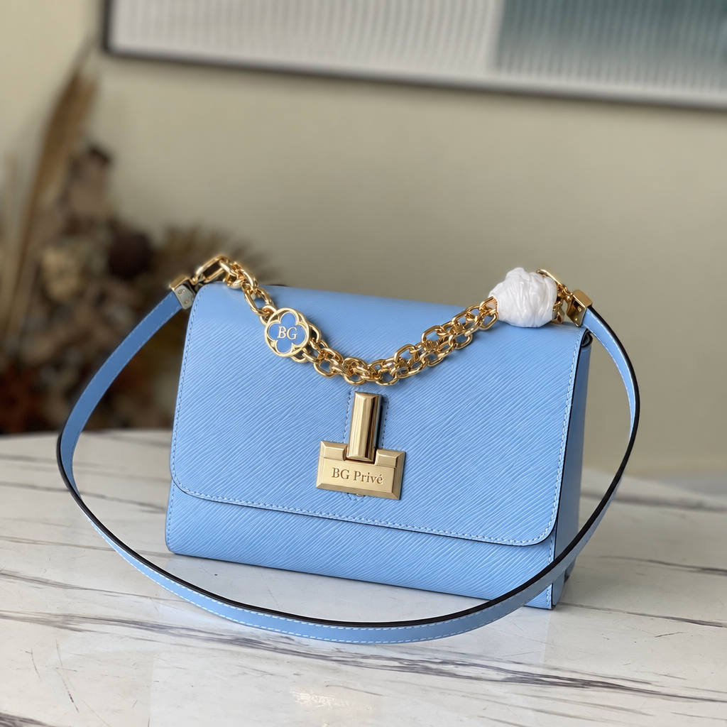 Twist MM in Bleu Nuage Epi Leather with Monogram Flower Chain