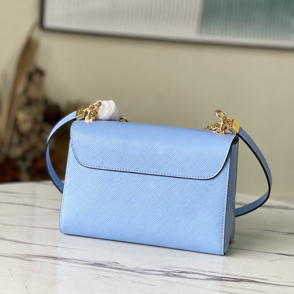 Twist MM in Bleu Nuage Epi Leather with Monogram Flower Chain